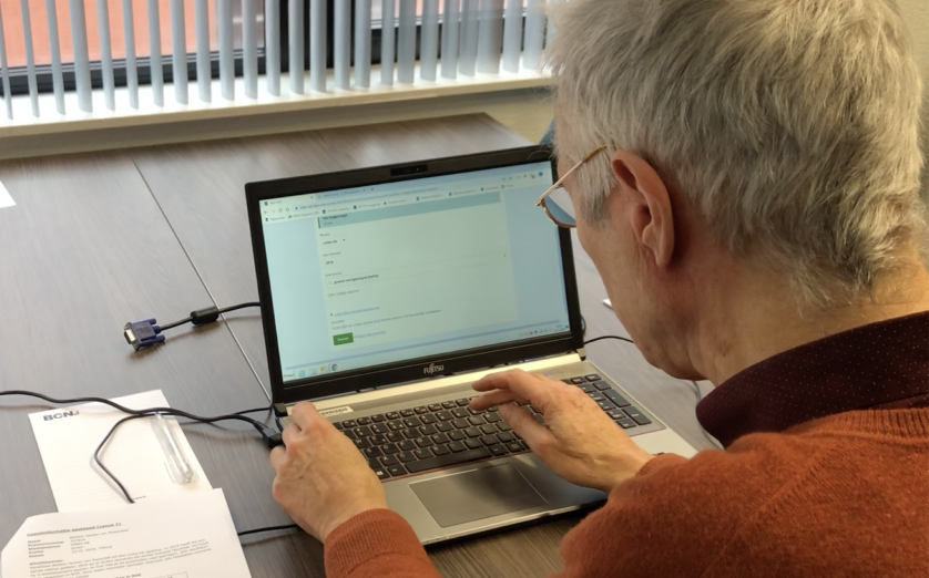 Image of man sitting behind laptop showing DUO website